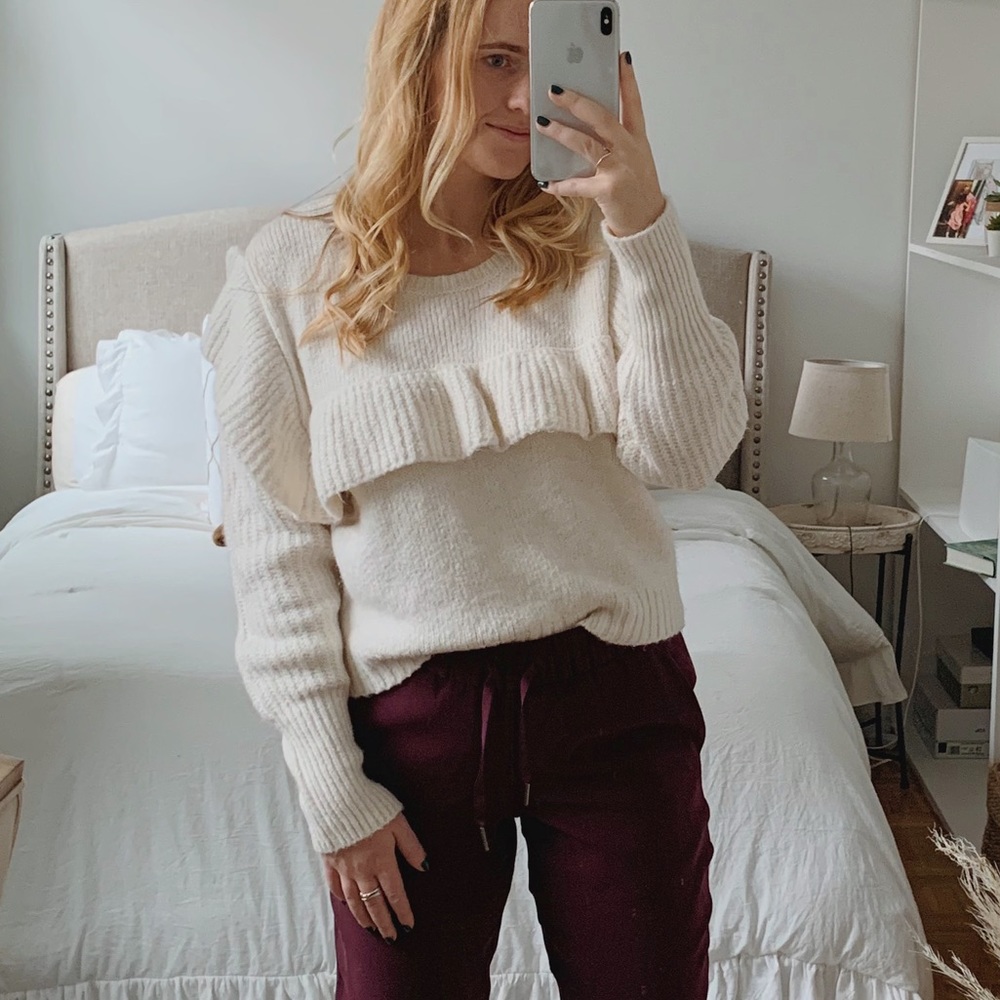 White sweater with ruffle detail